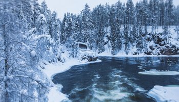 Das Foto zeigt einen winterlichen Blick auf die Landschaft des Oulanka-Nationalparks in Finnland.